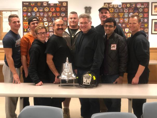 Brother's of Engine One with their bell